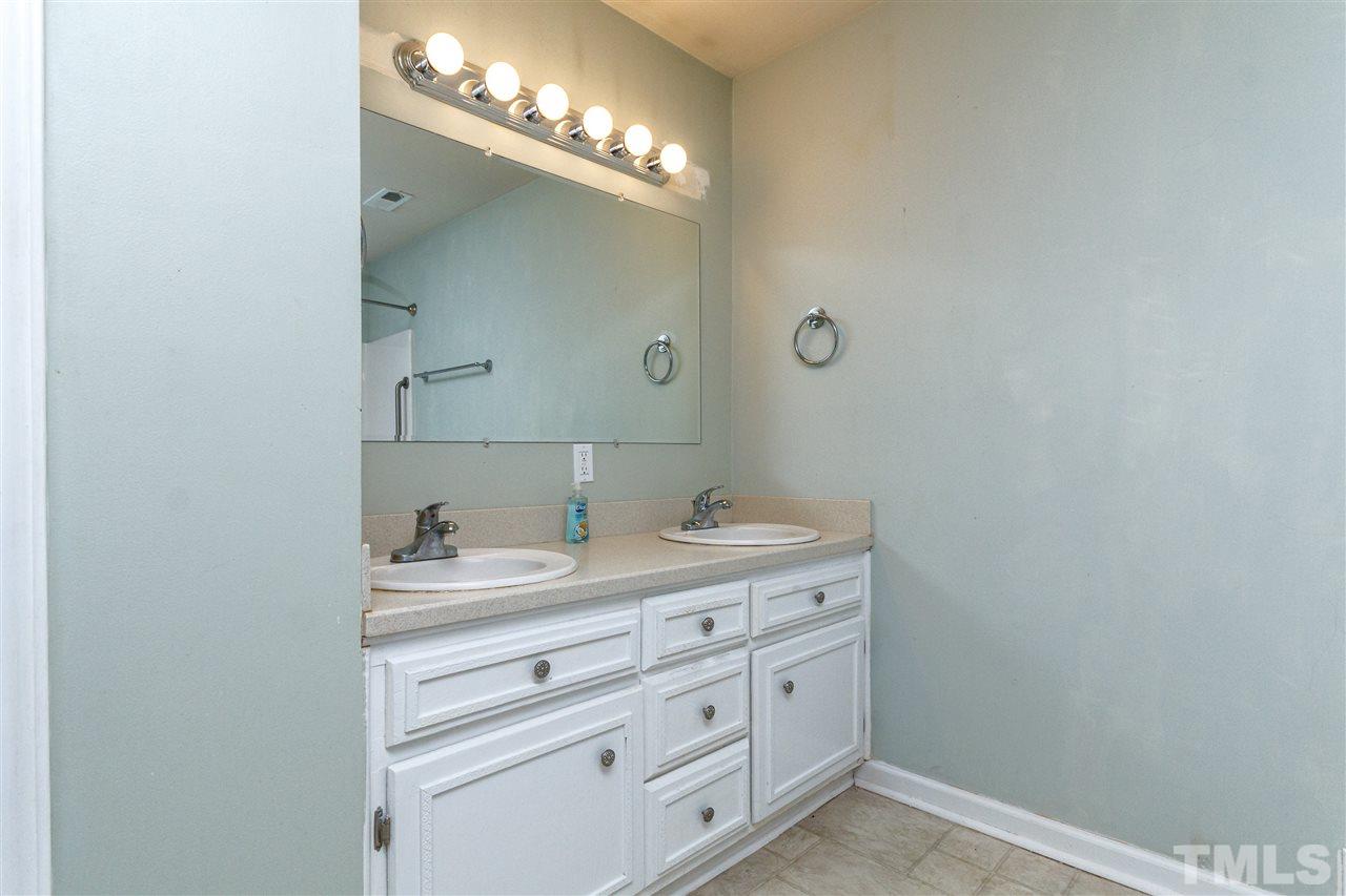 11604 Black Horse Run Raleigh, NC 27613 - Photo 18 of 29 a bathroom with a sink and a mirror