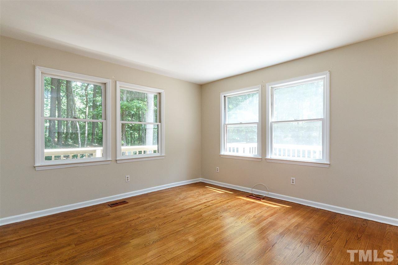 11604 Black Horse Run Raleigh, NC 27613 - Photo 3 of 29 a view of an empty room with wooden floor and a window