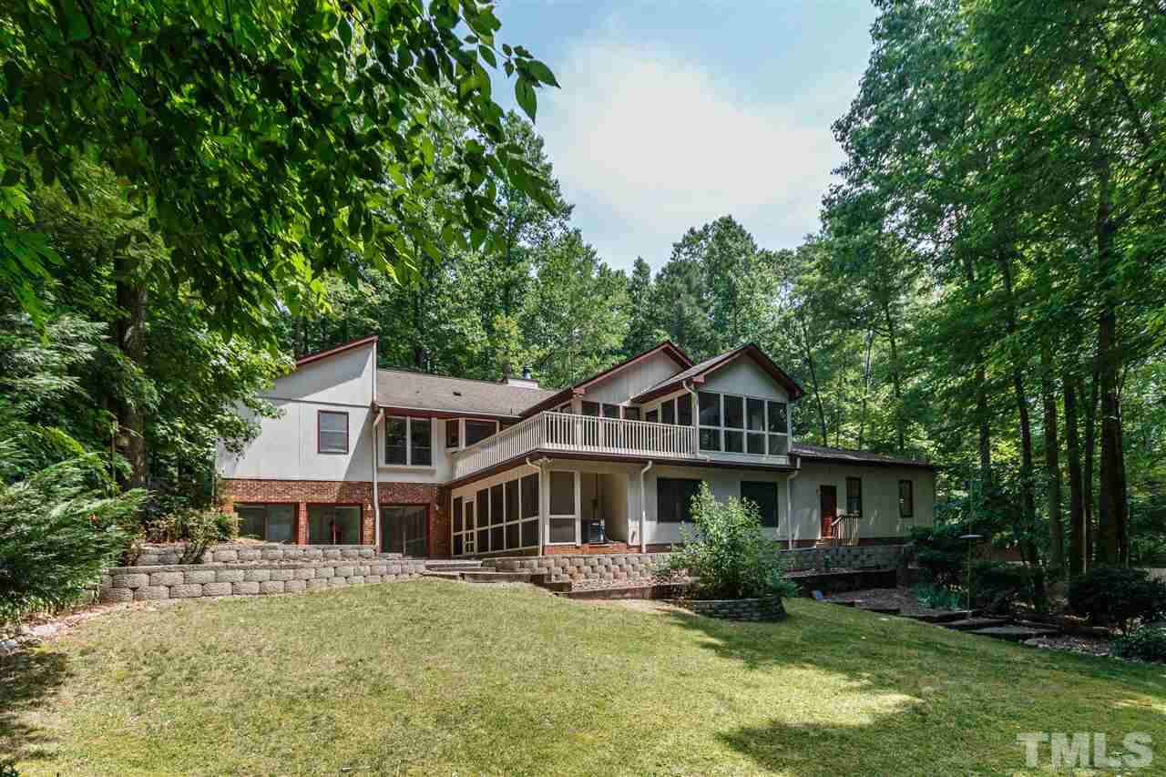 11604 Black Horse Run Raleigh, NC 27613 - Photo 22 of 29 a front view of a house with a garden and trees