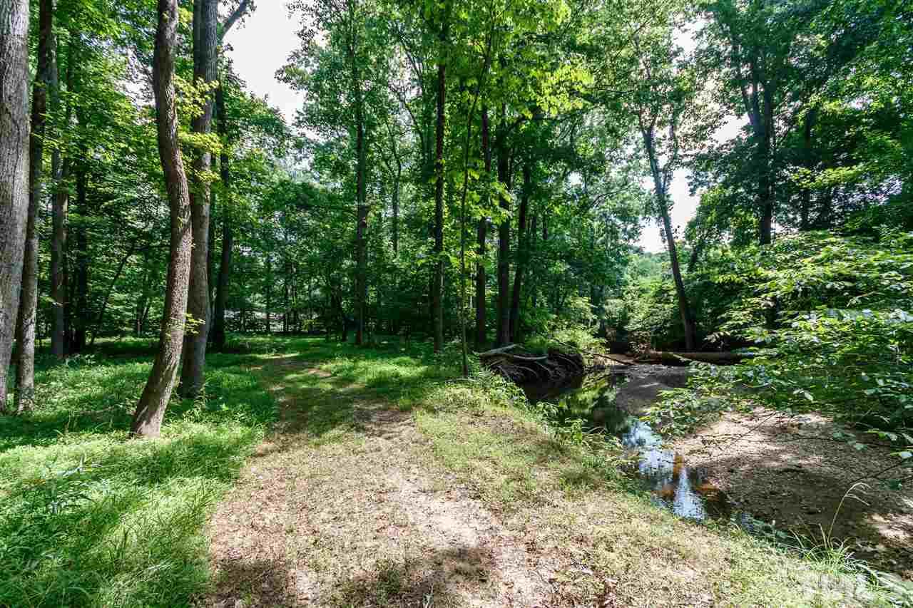 11604 Black Horse Run Raleigh, NC 27613 - Photo 25 of 29 a backyard of a house with lots of green space