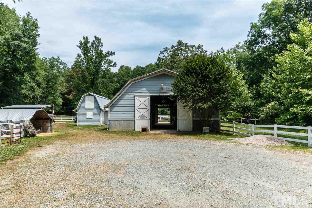 11604 Black Horse Run Raleigh, NC 27613 - Photo 28 of 29 a view of house with outdoor space and trees in the background