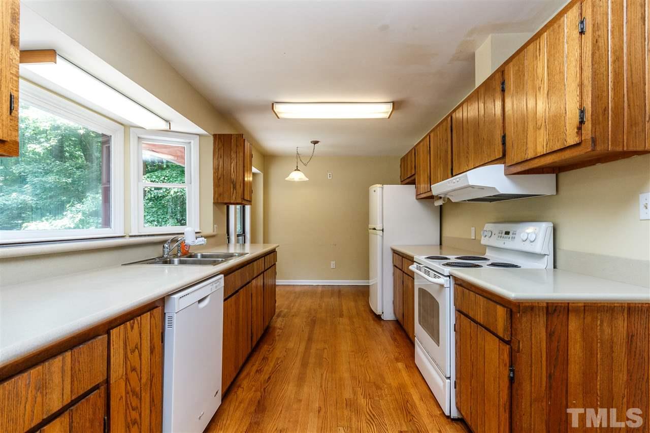 11604 Black Horse Run Raleigh, NC 27613 - Photo 6 of 29 a kitchen with stainless steel appliances granite countertop wooden cabinets a sink dishwasher a stove and a refrigerator