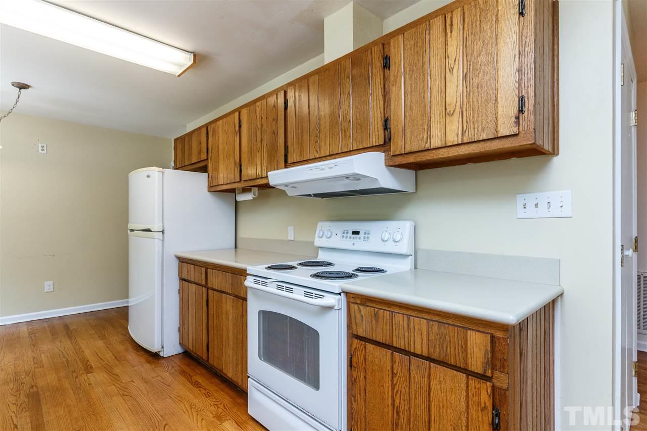 11604 Black Horse Run Raleigh, NC 27613 - Photo 8 of 29 a kitchen with stainless steel appliances granite countertop a stove a sink and a refrigerator