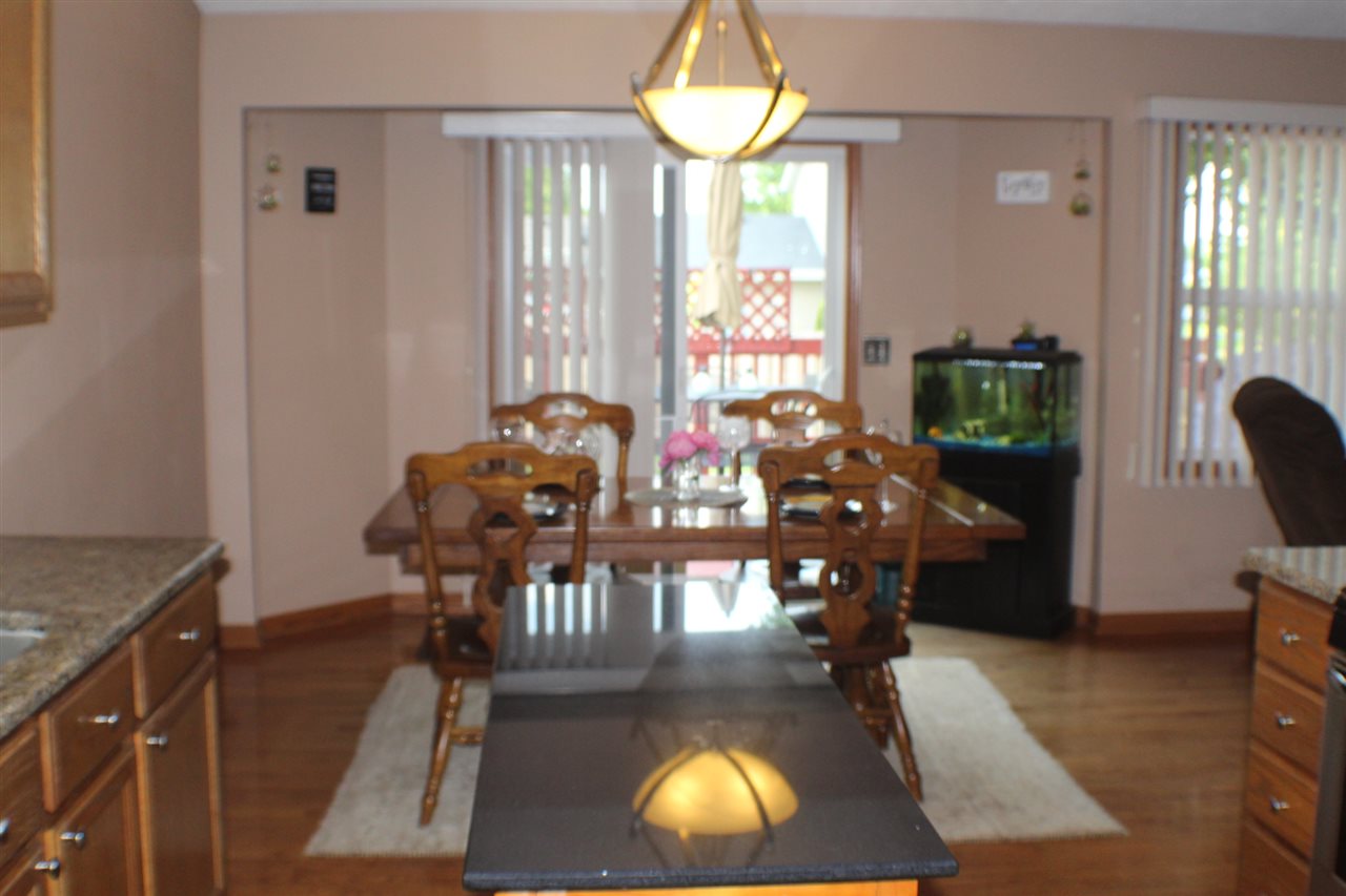 5375 Rockingham Drive Loves Park, IL 61111 - Photo 4 of 25 a living room with furniture a chandelier and a large window