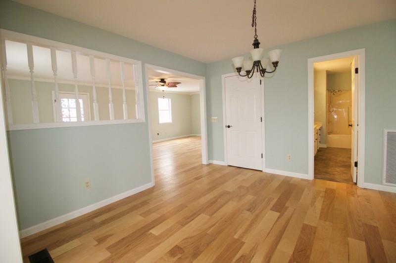 150 Redbud Road Red Boiling Springs, TN 37150 - Photo 4 of 15 wooden floor in an empty room with a window