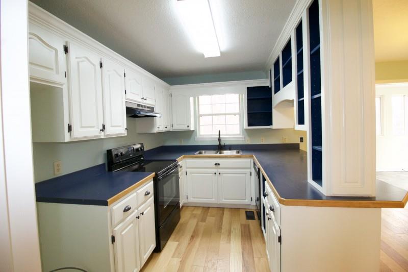 150 Redbud Road Red Boiling Springs, TN 37150 - Photo 5 of 15 a kitchen with stainless steel appliances granite countertop a sink stove and refrigerator