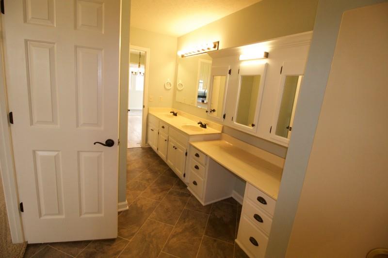 150 Redbud Road Red Boiling Springs, TN 37150 - Photo 8 of 15 a bathroom with double vanity and mirrors