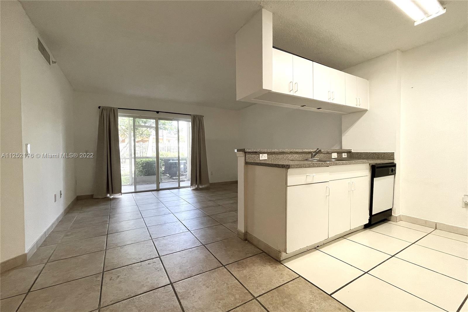 420 South Park Road, Unit 2105 Hollywood, FL 33021 - Photo 5 of 11 a kitchen with a stove top oven and cabinets