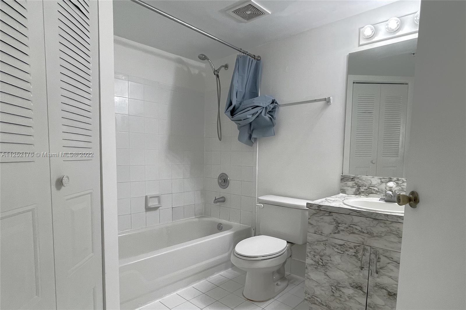 420 South Park Road, Unit 2105 Hollywood, FL 33021 - Photo 7 of 11 a bathroom with a granite countertop sink a toilet and shower