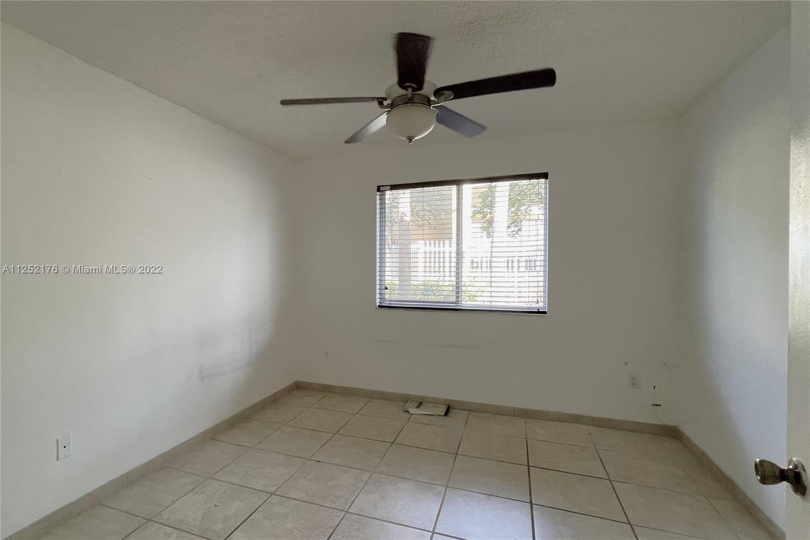 420 South Park Road, Unit 2105 Hollywood, FL 33021 - Photo 9 of 11 an empty room with ceiling fan and window