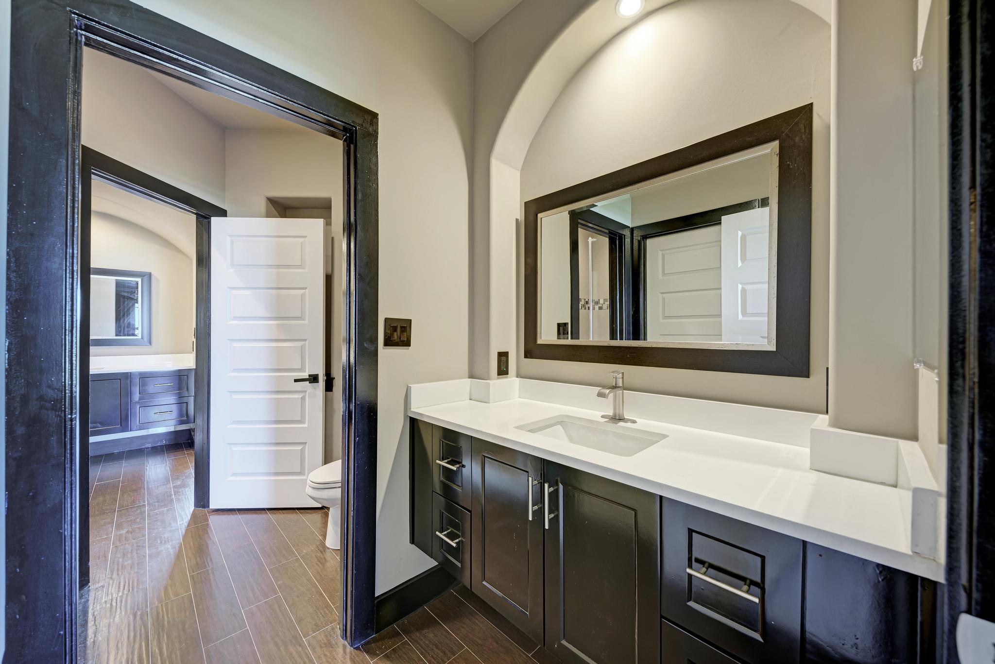 104 Spring Valley Street Hutto, TX 78634 - Photo 30 of 40 Bathroom featuring vanity and wood tiled floors