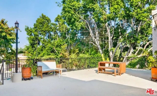 a backyard of a house with fire pit and chairs