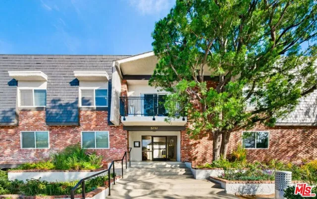 front view of a house with a tree