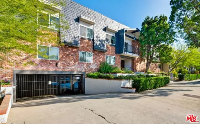 a front view of a building with garden