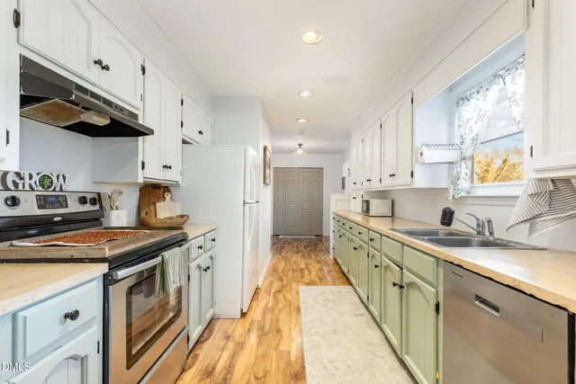 a kitchen with cabinets and a refrigerator