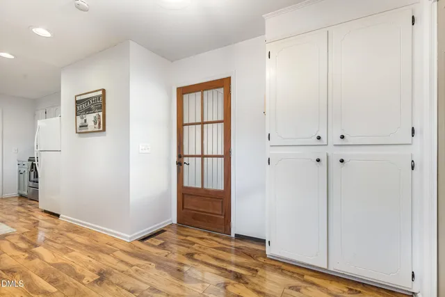 a large bedroom with a bed and a flat screen tv