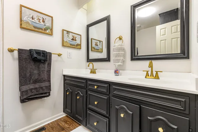 a bedroom with a bed and painting on the wall