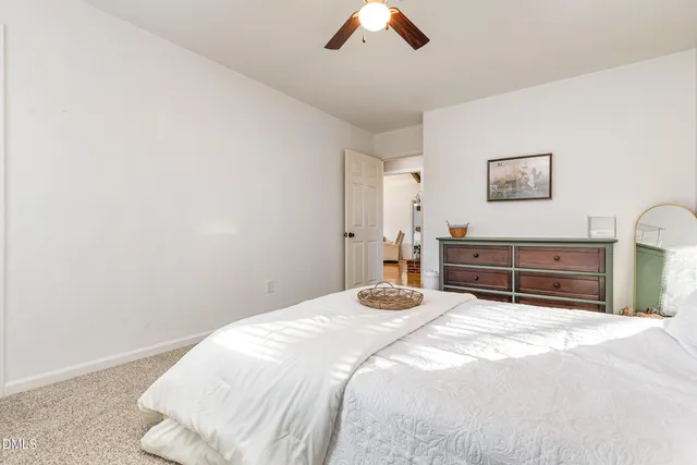 a bedroom with a bed and a tv on the dresser