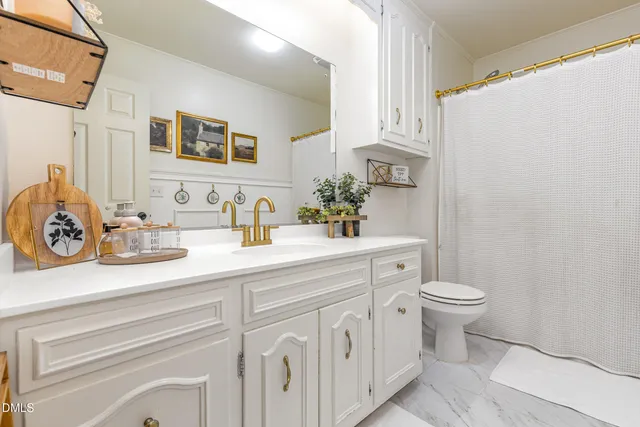 a bedroom with two beds and painting on the wall