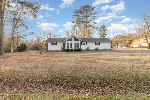 a living room with a couch and chairs