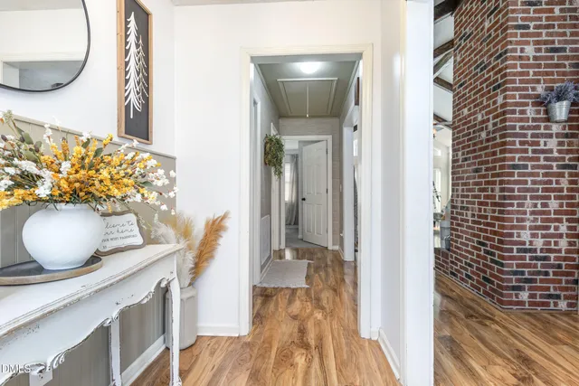a living room with furniture a flat screen tv and a floor to ceiling window