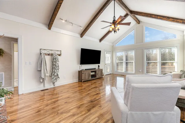 a living room with furniture and a wooden floor