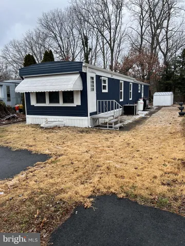 a view of a house with snow on the side of the road