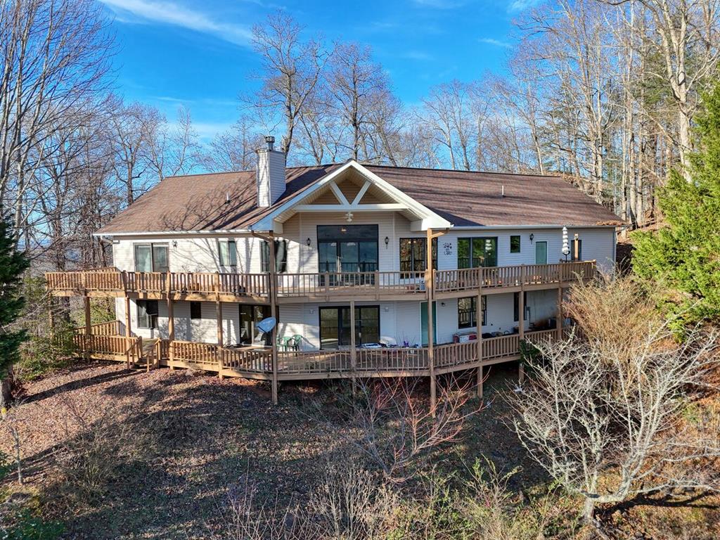 a front view of a house with a yard and lake view