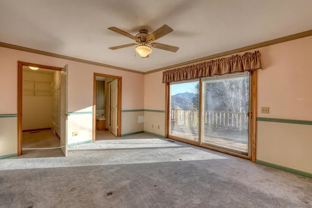 a view of a livingroom with a ceiling fan and window