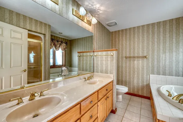 a white bath tub sitting in a bathroom next to a window