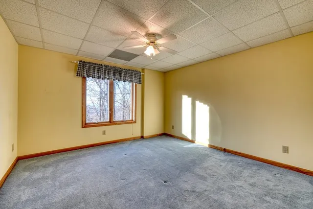 a view of empty room with a ceiling fan