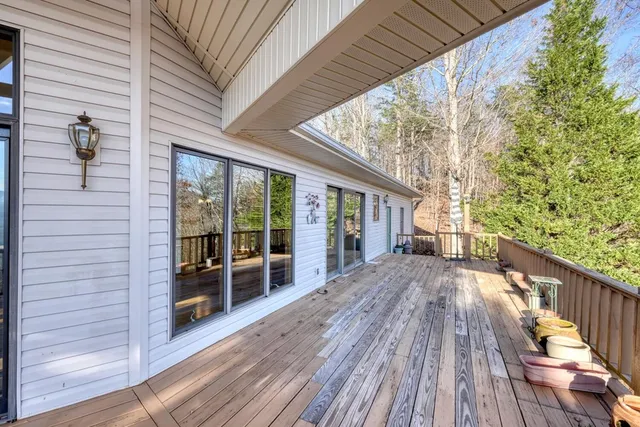 a view of a balcony with wooden floor and fence