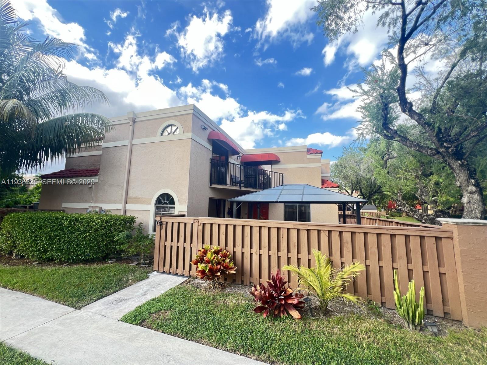 8116 Severn Drive, Unit C Boca Raton, FL 33433 - Photo 2 of 19 a view of a house with a yard and a garden