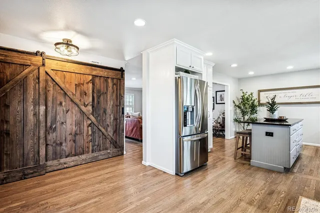 a kitchen with stainless steel appliances a refrigerator and a stove top oven