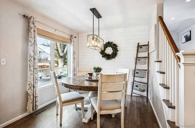 a dining room with furniture a chandelier and wooden floor