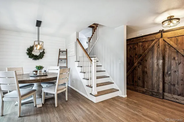 a view of entryway and hall with wooden floor