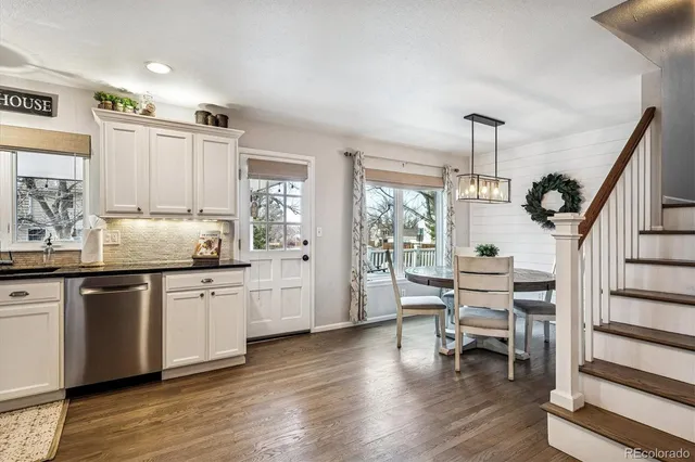 a kitchen with sink cabinets and wooden floor