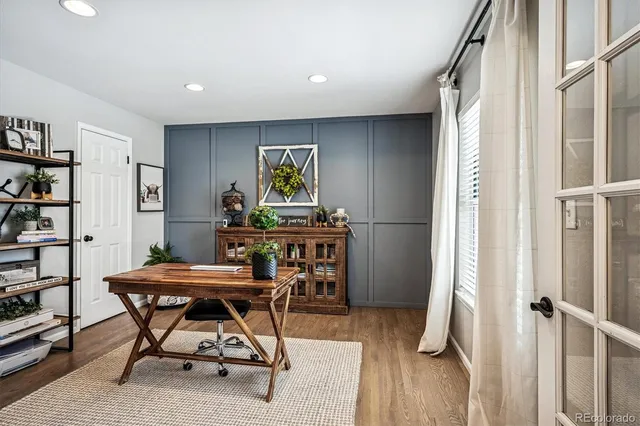 a view of a livingroom with furniture and a book shelf