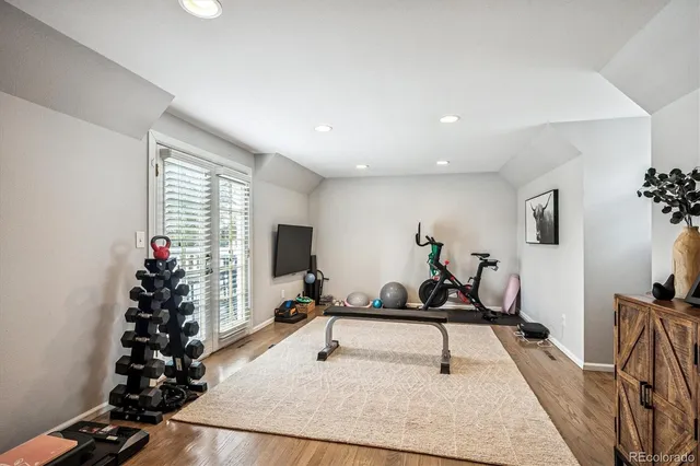 a room with lots of wooden furniture and windows