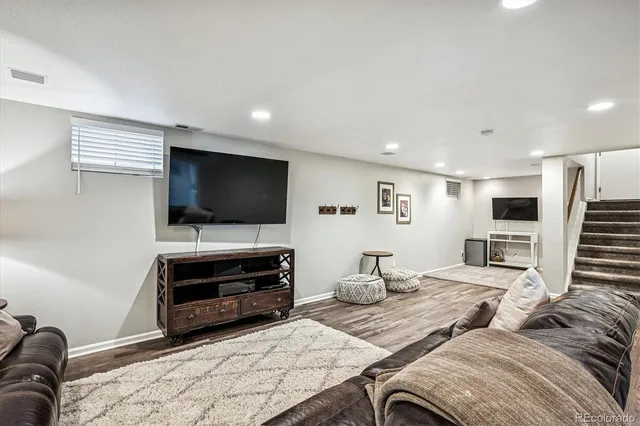 a bedroom with a bed couch and dresser