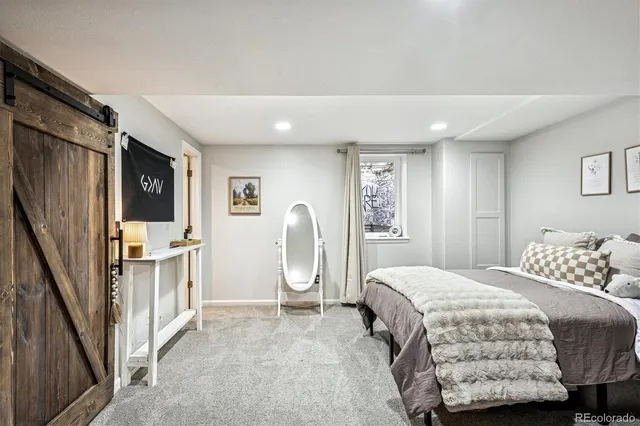 a bathroom with a toilet a sink a tub and mirror