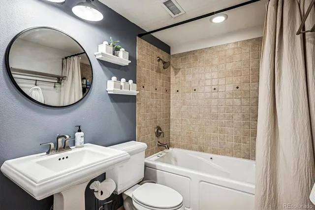 a dining room with furniture and a floor to ceiling window