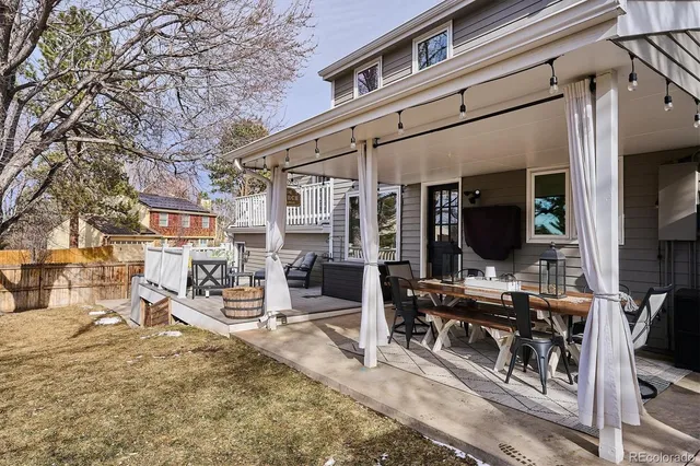 a backyard of a house with table and chairs