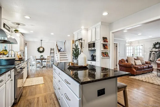 a kitchen with counter top space and living room