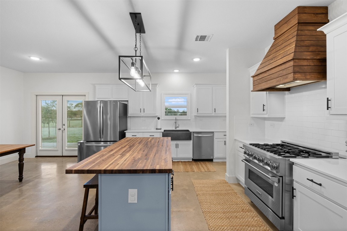 44206 Springer Road Hempstead, TX 77445 - Photo 11 of 43 a kitchen with kitchen island a counter space a sink stainless steel appliances and cabinets
