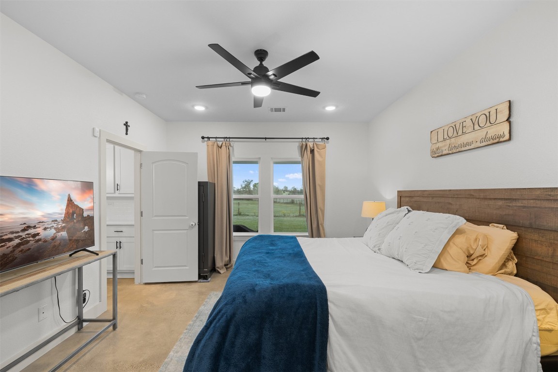 44206 Springer Road Hempstead, TX 77445 - Photo 18 of 43 a bedroom with a large bed and a flat screen tv