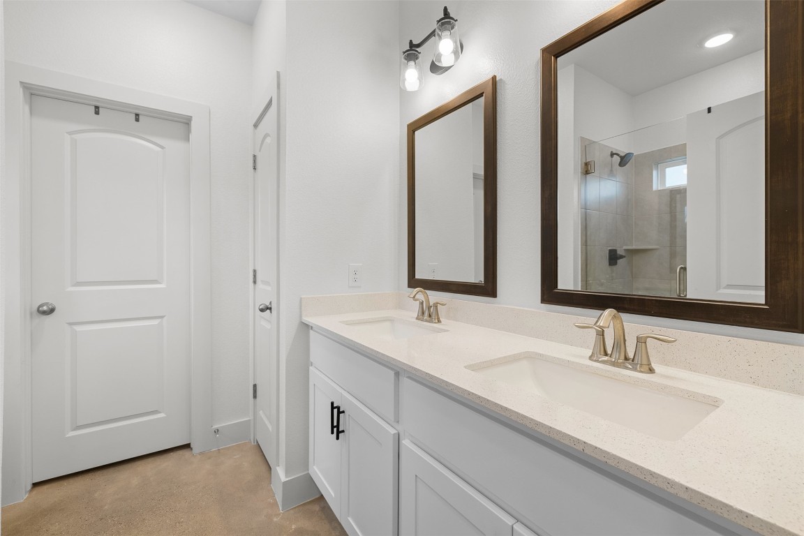 44206 Springer Road Hempstead, TX 77445 - Photo 19 of 43 a bathroom with double vanity sinks and a mirror