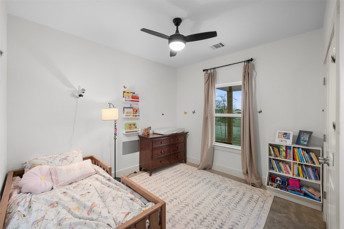 44206 Springer Road Hempstead, TX 77445 - Photo 20 of 43 a bedroom with a bed dresser and a book shelf