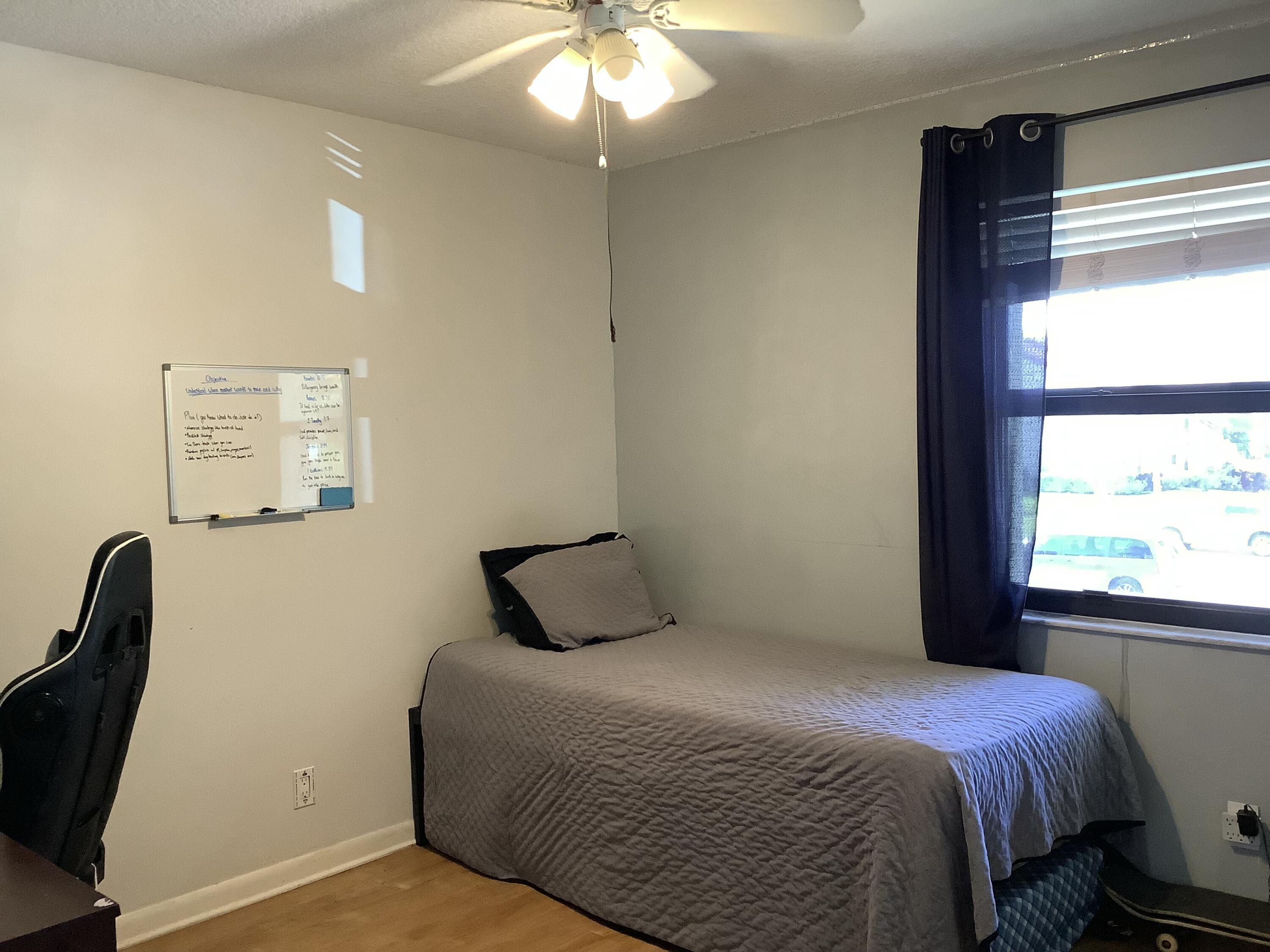 22040 Palms Way, Unit 204 Boca Raton, FL 33433 - Photo 11 of 20 a bedroom with a bed and a window