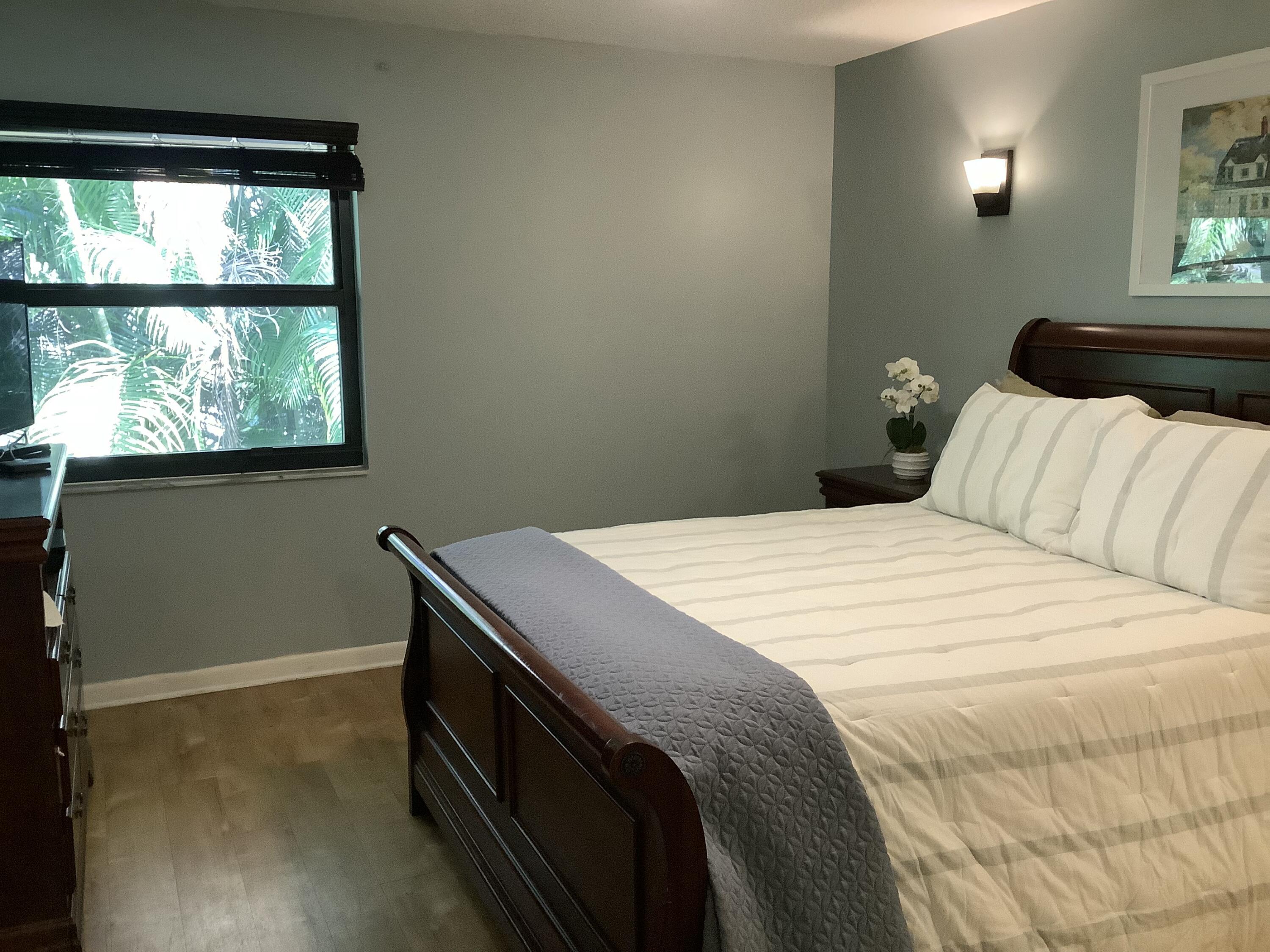 22040 Palms Way, Unit 204 Boca Raton, FL 33433 - Photo 13 of 20 a bedroom with a bed and a window